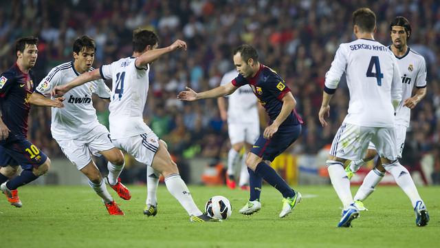 Iniesta surrounded by Real Madrid players last season. PHOTO: ÀLEX CAPARRÓS-FCB.
