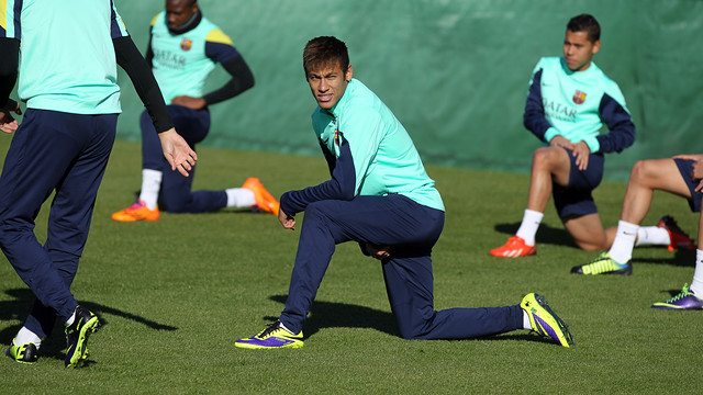 Neymar doing stretching exercises on the training ground pitch